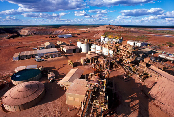 A gold mining industrial site located in a red sand landscape.