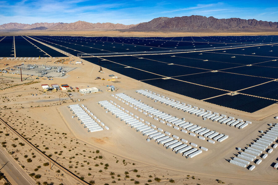 Aerial view of a large solar PV farm with battery energy storage units.