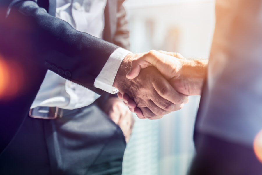 two businessmen shake hands